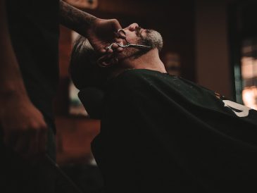 man sitting on barber's chair