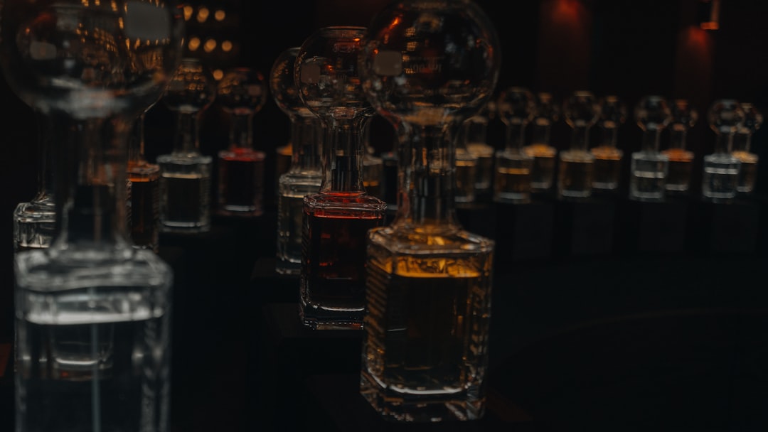 Row of glass bottles filled with colored liquids