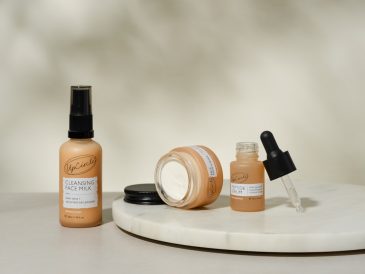 A white table topped with bottles of makeup
