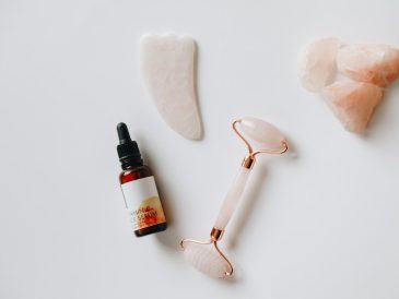 white and black plastic bottle beside white heart shaped ornament