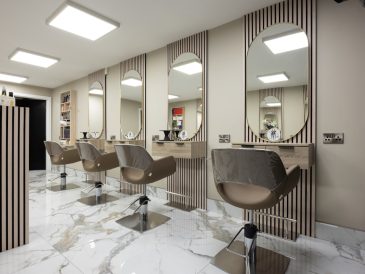 a hair salon with chairs and mirrors